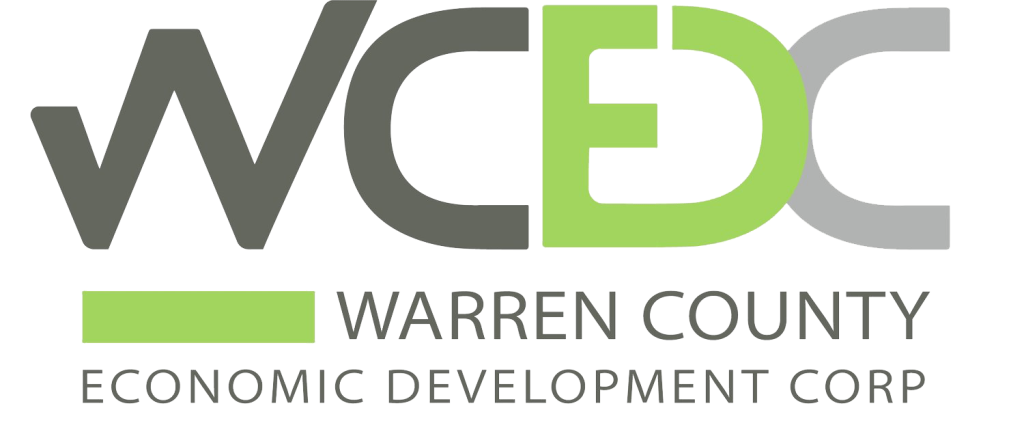 Logo for Warren County Economic Development Corp features "WCEDC" in bold letters. "Warren County Economic Development Corp" is written below in smaller text, with a green underline beneath "Warren County.